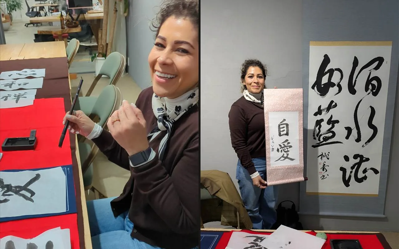 A smiling guest with her brush, and the same guest holding her finished hanging scroll
